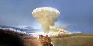 A large mushroom cloud rising into the sky from a nuclear explosion