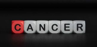 Blocks spelling the word 'CANCER' with one block in red