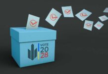 A blue voting box with ballot papers being cast into it for the 2028 election