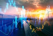 A landscape featuring solar panels and wind turbines with data graphs overlaying the sunset