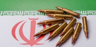 A collection of bullets resting on the Iranian flag