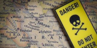 A danger sign placed over a map of the Middle East