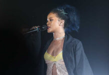 Rihanna performing on stage with a microphone