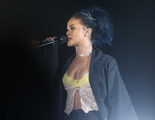 Rihanna performing on stage with a microphone