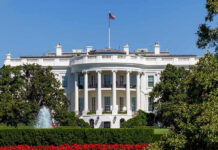 Trump Building Combat Arena at White House White House with trees and fountain.