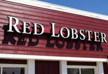 Signage of Red Lobster restaurant against a blue sky