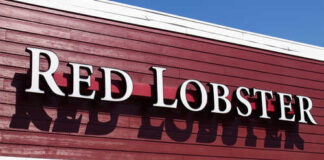 Signage of Red Lobster restaurant against a blue sky