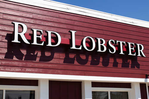Signage of Red Lobster restaurant against a blue sky