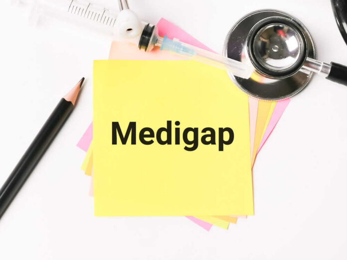 A yellow sticky note with the word 'Medigap' surrounded by medical tools and colored paper