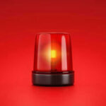 Red emergency light on solid red background.