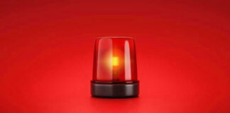 Red emergency light on solid red background.