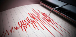 Seismograph recording earthquake activity in red.