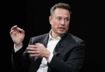 Elon Musk in a suit talking.