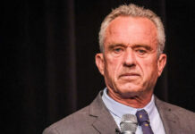 Robert F. Kennedy JR holding microphone.