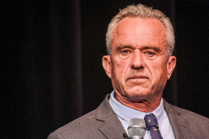 shutterstock_2341983421.jpg Robert F. Kennedy JR holding microphone.