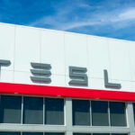 Tesla building with logo against blue sky