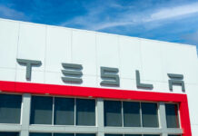 Tesla building with logo against blue sky