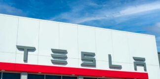 Tesla building with logo against blue sky