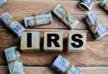 IRS Numbers Stun: Refunds Jump 10% Wooden blocks spelling IRS surrounded by rolled currency notes