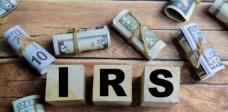 IRS Numbers Stun: Refunds Jump 10% Wooden blocks spelling IRS surrounded by rolled currency notes