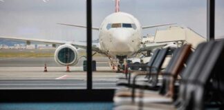 View of an airplane from an airport waiting area