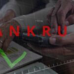 Hands using a smartphone with a financial chart and the word 'BANKRUPT' overlayed