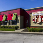 Exterior view of a Chili's restaurant with colorful awnings