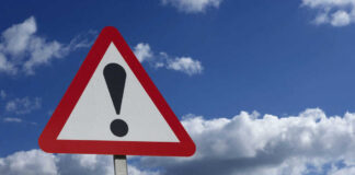 Red-Light Runner STRIKES Celeb and Children Warning sign with exclamation mark against sky