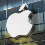 Apple logo displayed prominently on a glass storefront