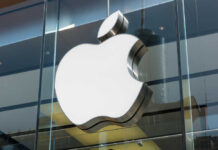 Apple logo displayed prominently on a glass storefront