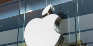 Apple logo displayed prominently on a glass storefront