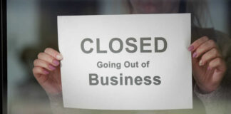 Iconic Beer Vanishes — What’s the Real Reason? A person holding a sign that reads 'CLOSED Going Out of Business'