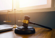 Democrat SLASHES Sentence for Trump Ally Gavel and scales of justice on desk.