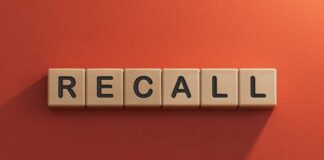 The word 'RECALL' displayed in wooden letter blocks against a red background