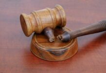Shocking Execution Drama — Was He Guilty? A wooden gavel resting on a circular base