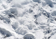 An avalanche cascading down a snowy mountain
