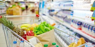 Grilling Costs Soar: 28% Price Jump! A shopping cart filled with fresh fruits, vegetables, and groceries