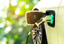 Electric Vehicle Gamble Sparks Outrage Electric car charging at a charging station.