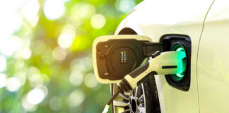Electric Vehicle Gamble Sparks Outrage Electric car charging at a charging station.