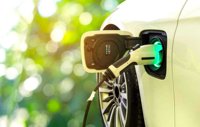 Electric car charging at a charging station.