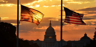 House Rebels Battle Trump Silhouetted American flags in front of the Capitol building during sunset