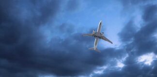 An airplane flying through a cloudy sky