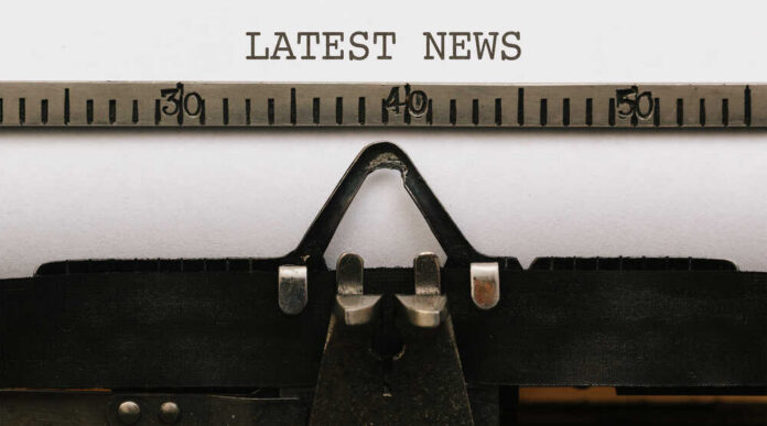 Close-up of a typewriter with a sheet of paper displaying the words 'LATEST NEWS'