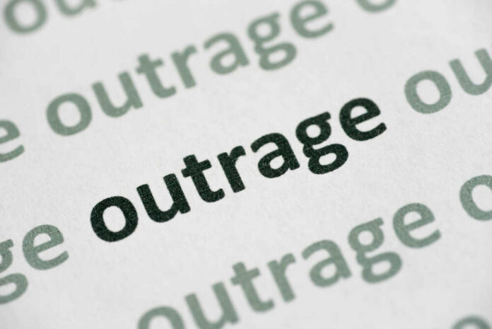 Word,Outrage,Printed,On,White,Paper,Macro Close-up of the word 'outrage' printed in bold on paper