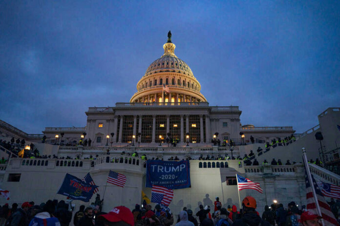shutterstock_1913478496 People and Trump supporters outside U.S. Capitol building.