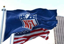 NFL flag waving in front of American flag.