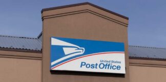 Stamp Shock Hits As USPS Cash Crisis Revealed Row of blue United States Postal Service mailboxes