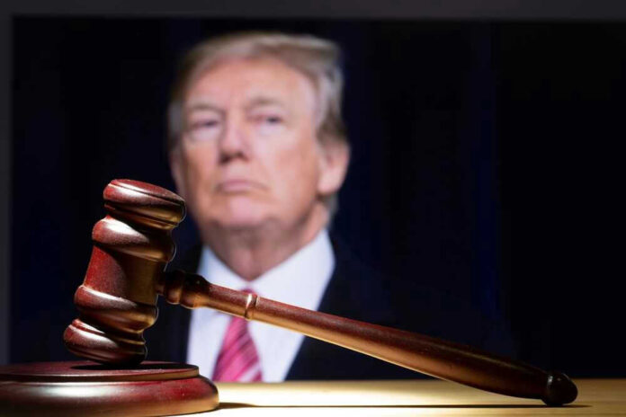 Gavel in foreground with blurry man in background.