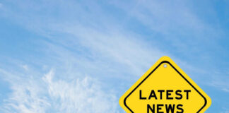 Yellow sign with text Latest News on sky background