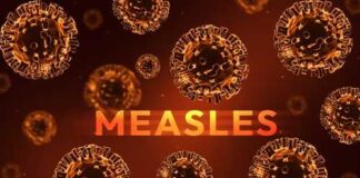 Illustration of measles virus particles with the word 'MEASLES' in bold